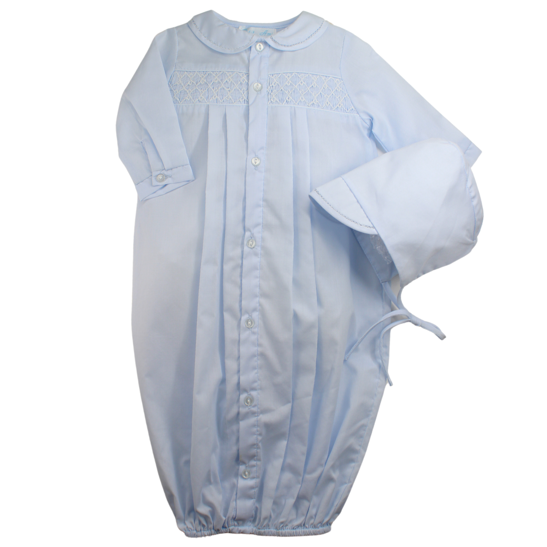 A newborn boys blue smocked gown and bonnet set to bring baby home from hospital.