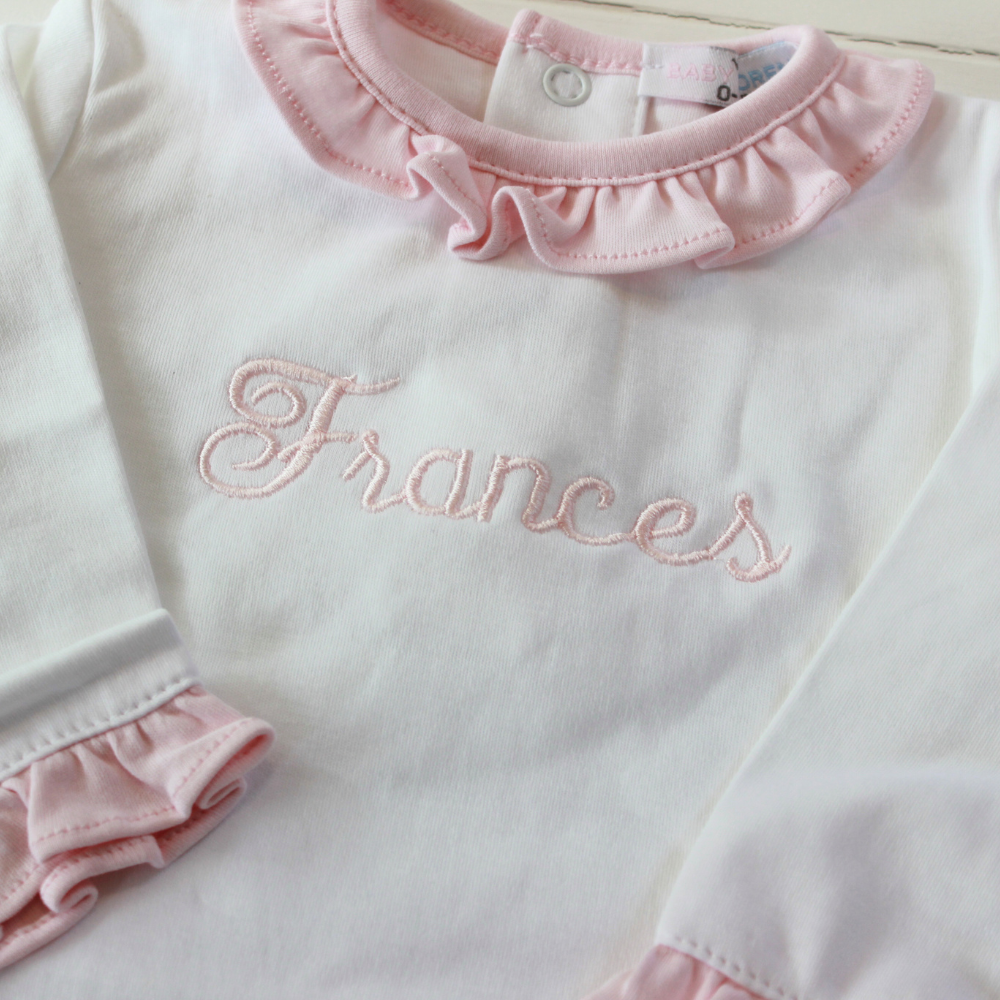 White baby girl take home outfit with pink ruffle collar personalized name on chest